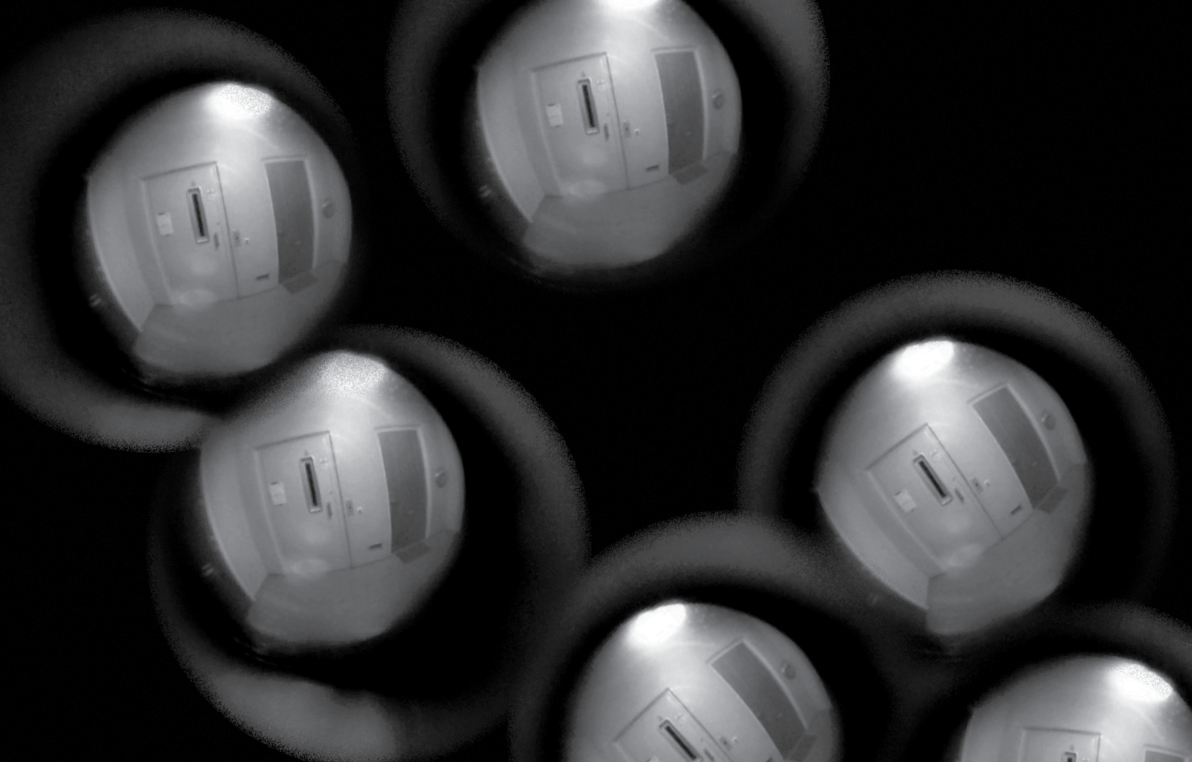 An abstract image of bubbles that look like frog eggs, which contain a scene that appears to be a view out a peephole