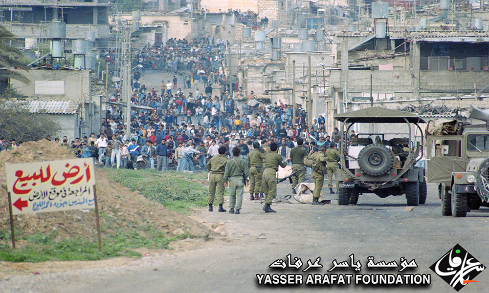 Israeli military shooting at Palestinian men, ca. 1988. Source: Yasser Arafat Foundation online gallery.