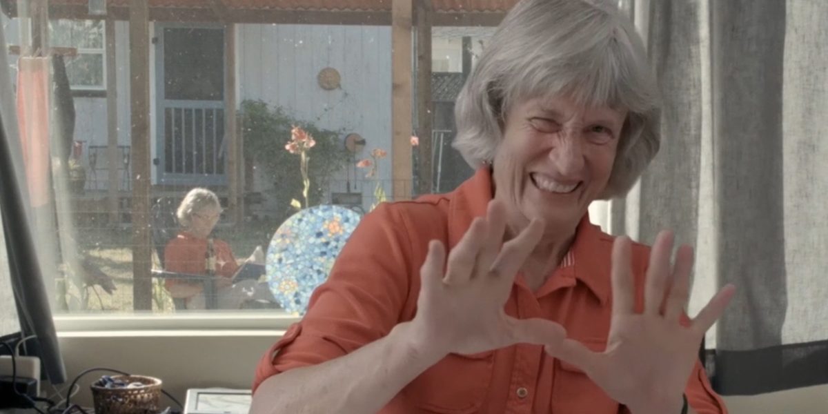Donna Haraway at her desk, smiling. 